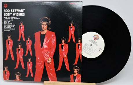 Vinyl record with a red-suited album cover featuring Rod Stewart's 'Body Wishes'.