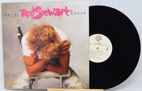 Vinyl record with cover featuring a person hugging themselves, titled 'Out of Order' by Rod Stewart.