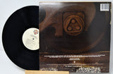 Vinyl record with its cover featuring a metal gear design on a white background