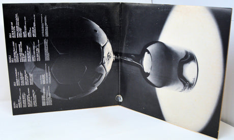 Open book with black and white images of a sphere on a white background