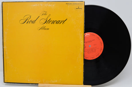 Vinyl record with yellow cover titled 'The Rod Stewart Album' on a white background