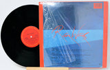 Vinyl record with red label and blue cover featuring 'Roger Waters' on a white background