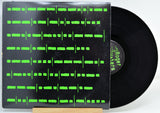 Vinyl record by Roger Waters, titled Radio KAOS with a black cover featuring green text on a white background