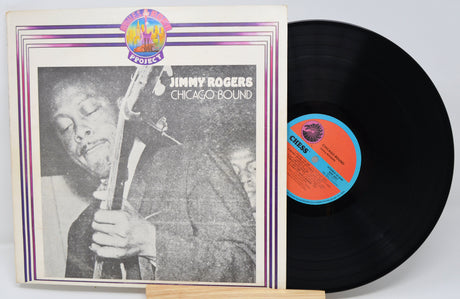Vinyl record and cover featuring Jimmy Rogers with a jazz instrument, on a light gray background.