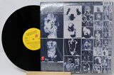 Vinyl record with a cover featuring black and white images of faces and a yellow label.