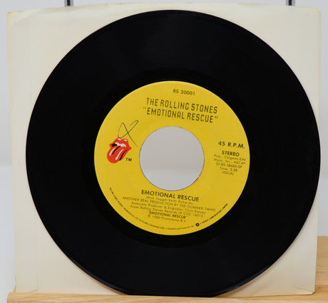 Vinyl record with yellow label featuring The Rolling Stones on a white background
