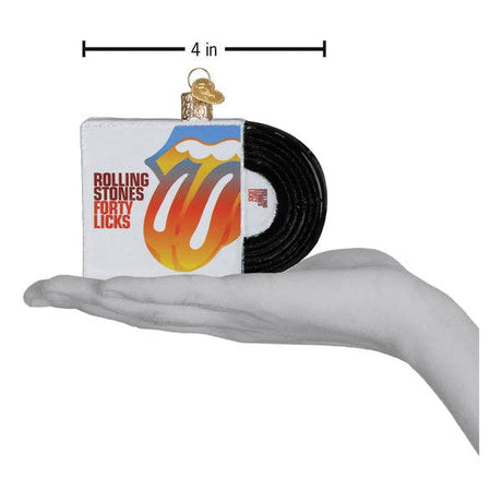 Hand holding a Rolling Stones Forty Licks album ornament with record detail