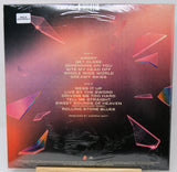 Back cover of a vinyl record sleeve for Rolling Stones 'Angry', sealed in plastic shrink wrap, with tracklist text and abstract pink and black geometric artwork.