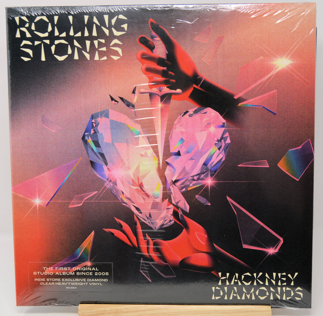 Rolling Stones 'Hackney Diamonds' vinyl record album, sealed in plastic shrink wrap and displayed on a wooden stand against a white background.
