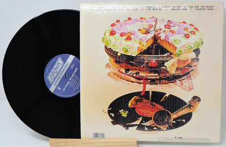 Vinyl record with a colorful album cover featuring a guitar and cake.