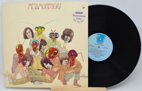 Vinyl record with cover featuring artistic design of people with insect heads on a beige background.