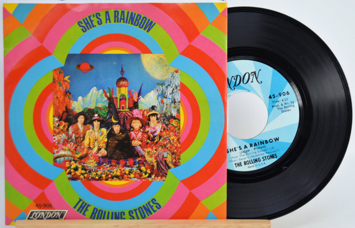 Vinyl record and cover of 'She's a Rainbow' by The Rolling Stones with colorful design.