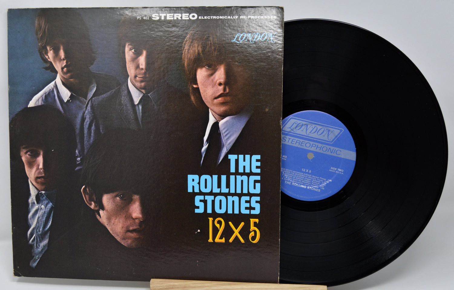 Vinyl record with cover featuring The Rolling Stones, on a white background