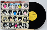 Vinyl record with colorful cover featuring album art of The Rolling Stones' 'Some Girls' on a white background.