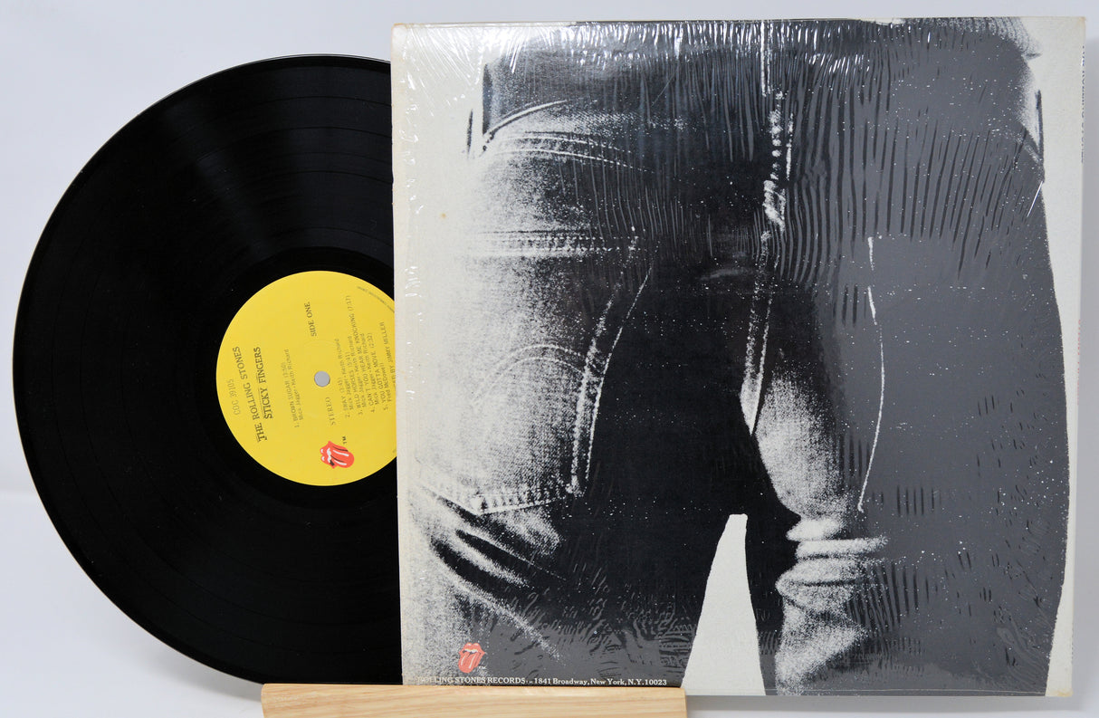 Vinyl record with a cover featuring a black and white image of a person in jeans.
