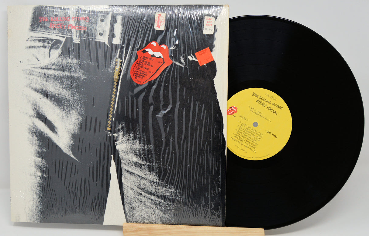 Vinyl record with a black and white cover featuring a zipper and red tags.