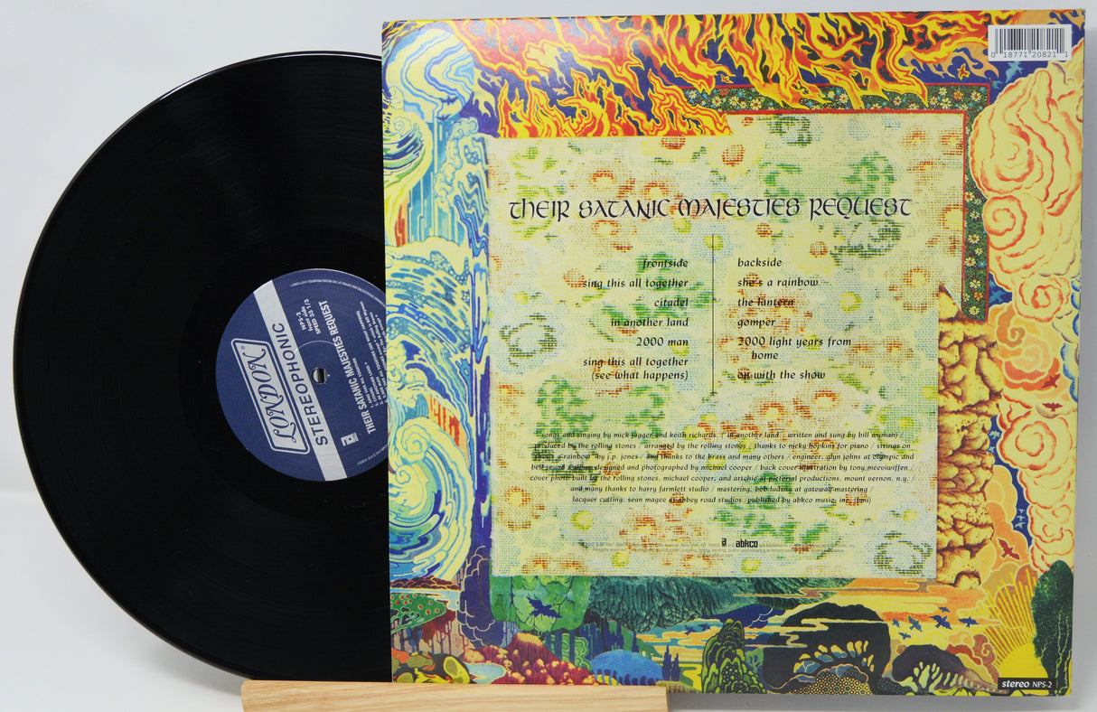 Vinyl record with colorful cover featuring text and artistic designs.