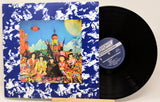 Vinyl record with colorful cover featuring people and a castle, on a white background.