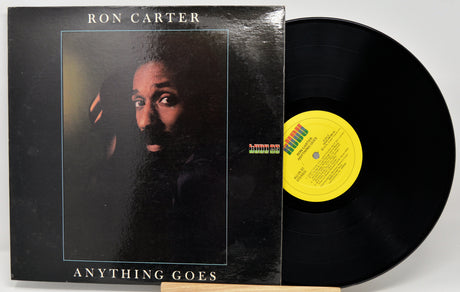 Ron Carter's 'Anything Goes' vinyl record LP, showing the black album cover with a portrait and the black record partially pulled out, revealing a yellow label.