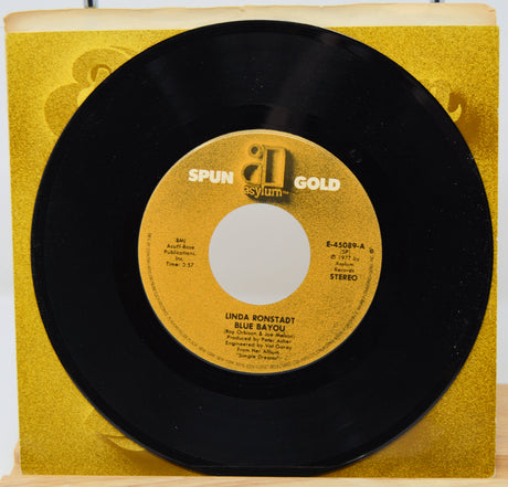 7-inch vinyl record with yellow label on a matching yellow sleeve