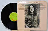 Vinyl record with a green label and its packaging featuring a person on the cover.