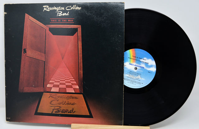 Vinyl record with a mountain-themed cover featuring a person holding a suitcase.