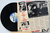 Vinyl record with a cover featuring black and white images and text.