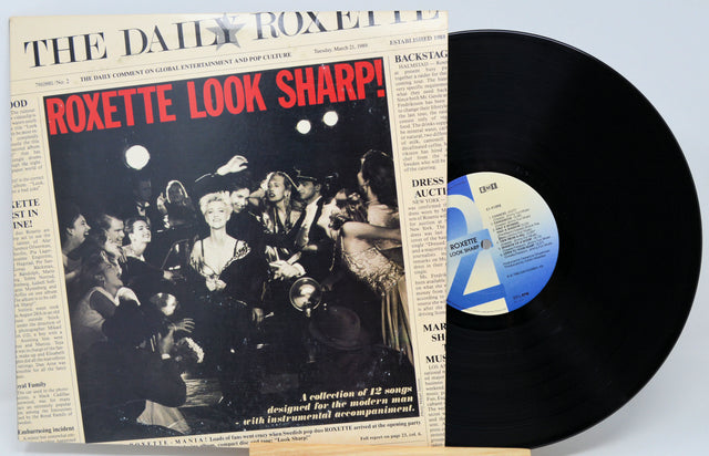 Vinyl record with 'Roxette Look Sharp!' album cover on a light blue background