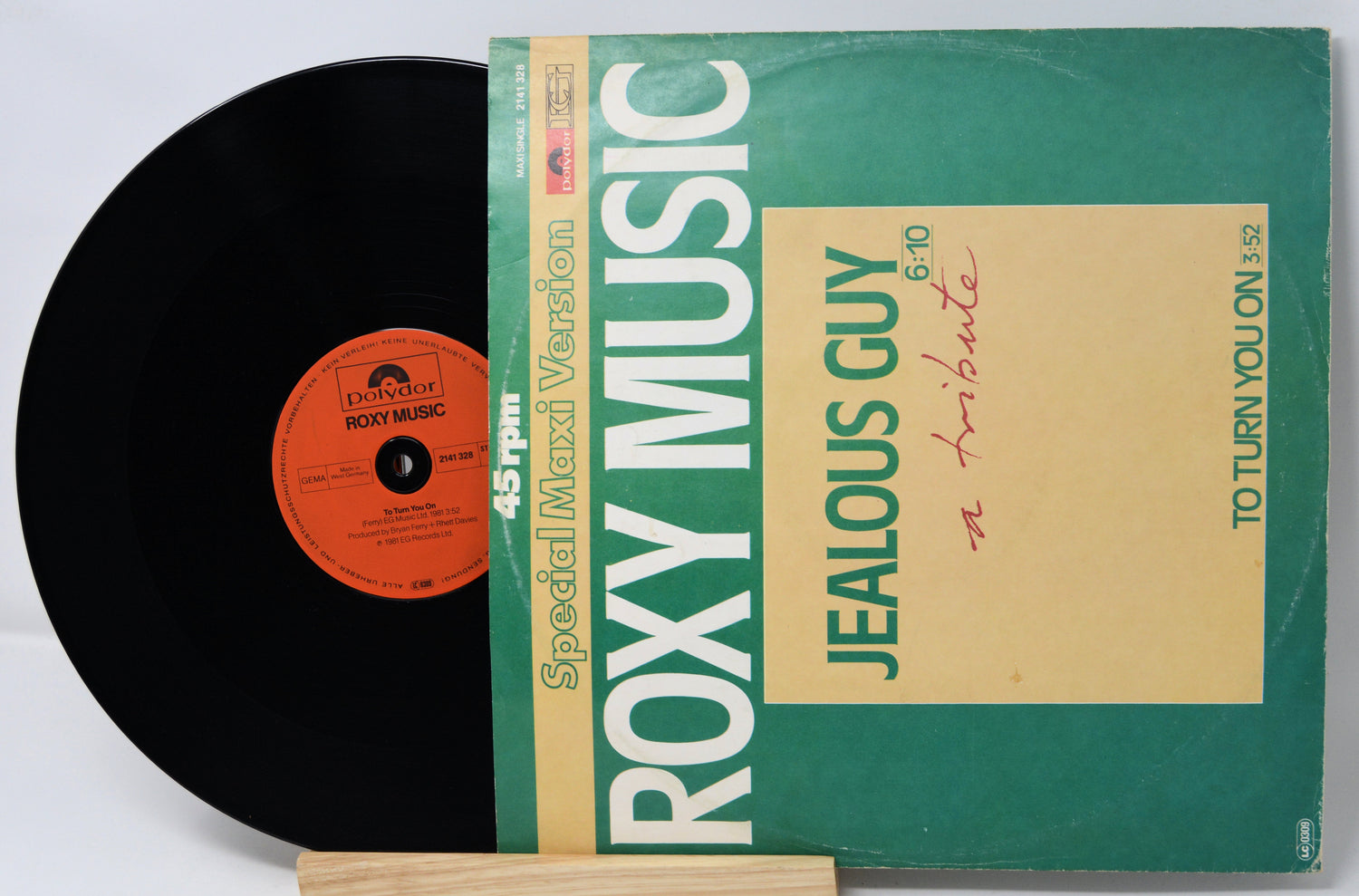 Vinyl record with green cover featuring 'Roxy Music' and 'Jealous Guy' text.