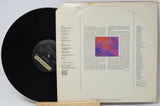 Vinyl record with cover featuring text and a colorful abstract design on a white background