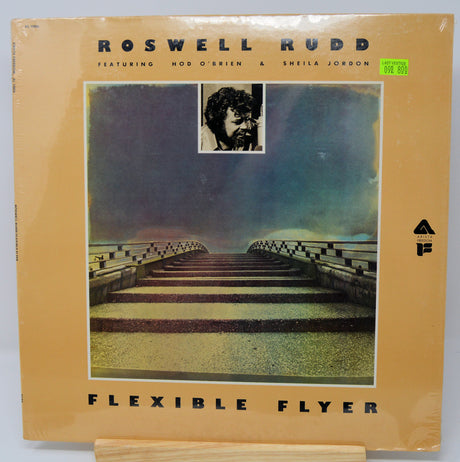 Vinyl record cover for 'Flexible Flyer' by Roswell Rudd featuring a man's face and a bridge.