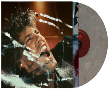 Vinyl record with a person's face through glass and a close-up of the record label.