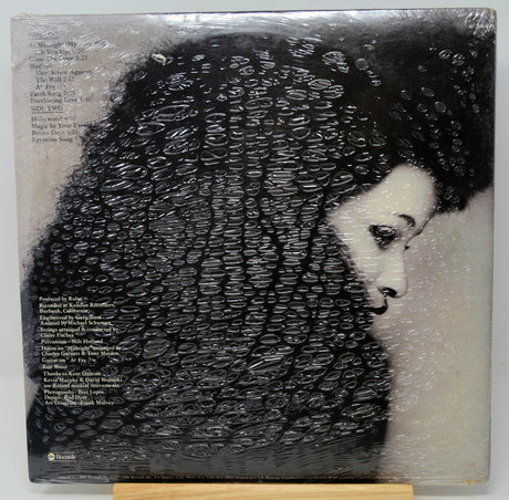 Vinyl record album cover for Bob Dylan's 'The Freewheelin'' album, wrapped in protective plastic with a small wooden display stand visible at the bottom.