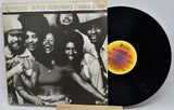 Vinyl record with cover featuring a group of people, including Chaka Khan, on a white background.