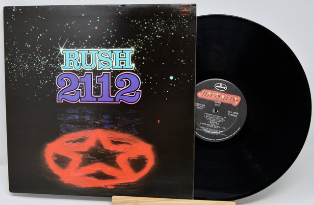 Vinyl record with 'Rush 2112' cover featuring a star design on a black background.
