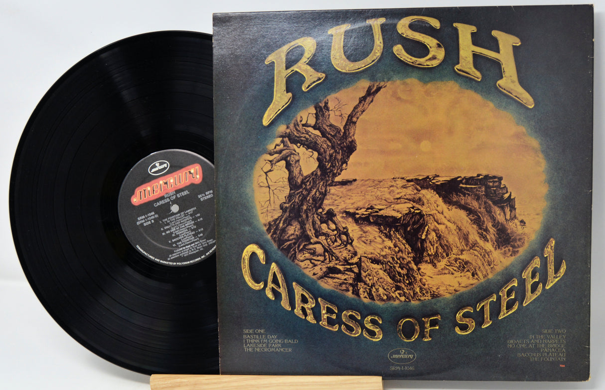 Vinyl record and cover of 'Caress of Steel' by Rush on a white background