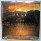 Rush - Back on Black Rock Classics vinyl record album cover, showing a dramatic mountain landscape under a golden sunset sky with the band name 'RUSH' in large white letters.
