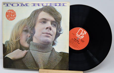 Vinyl record with cover featuring a man and a woman, and a visible label.