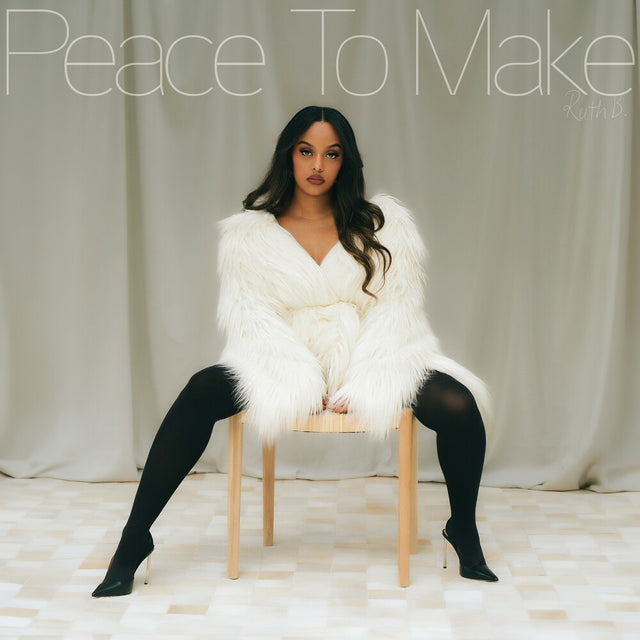 Person wearing a white fur coat sitting on a chair with text overlay