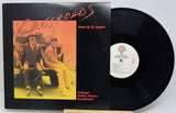 Vinyl record with cover featuring two men sitting on a bench, titled 'Crossroads'.