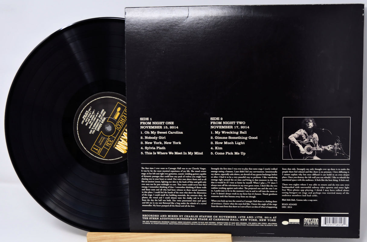 Vinyl record with cover displaying text and a photo of a person playing guitar.
