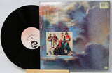 Vinyl record with cover featuring a group of people against a colorful abstract background