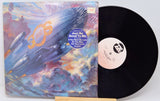 Vinyl record with a colorful cover featuring an airplane and a white label.