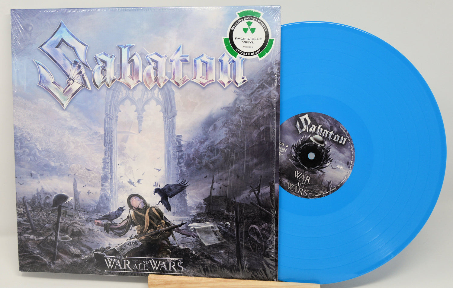 Front cover and Pacific Blue vinyl of Sabaton's The War to End All Wars, featuring limited edition sticker