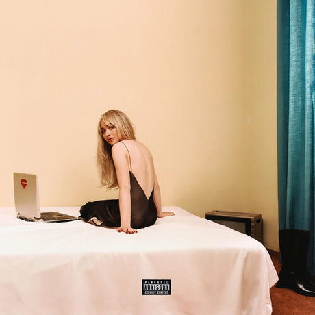 Album cover with a person sitting on a bed next to a laptop, with a visible record label logo.