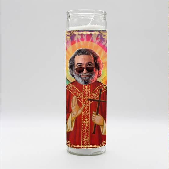 Devotional candle featuring a saintly figure with sunglasses and a colorful halo background