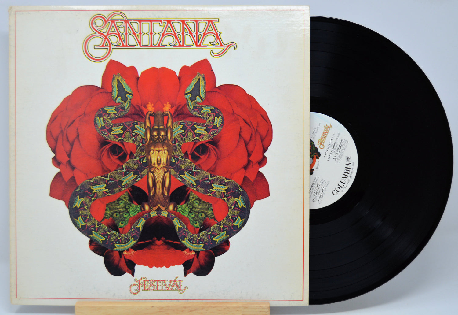 Vinyl record with a colorful cover featuring the band name 'Santana' titled 'Festival' and a red and black design.