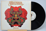 Vinyl record with a colorful cover featuring the band name 'Santana' titled 'Festival' and a red and black design.