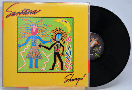 Vinyl record with colorful cover featuring two abstract figures and the title 'Shango' by Santana.