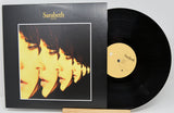 Front cover of Sarabeth Tucek vinyl album featuring repeated profile portraits and included record